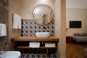 a bathroom with a sink and a mirror at Palazzo Gulino in Palma di Montechiaro