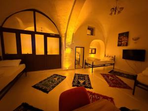 a living room with a door and some rugs at Ro House in Mardin