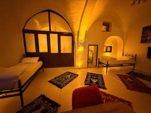 a room with two beds and rugs on the floor at Ro House in Mardin +2 photos