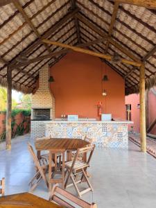 a patio with a table and chairs and a bar at BobZ Concept in Barrinha