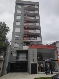 a tall building with a parking lot in front of it at Salvia in Trenque Lauquen +4 photos