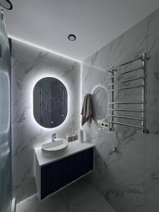 a bathroom with a sink and a mirror at Alvina Private Yard Apartment in Tsaghkadzor +18 photos