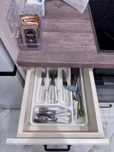 a drawer in a kitchen with utensils in it at Alvina Private Yard Apartment in Tsaghkadzor