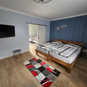 a bedroom with a large bed and a rug at Gartenblick Trebbin in Trebbin