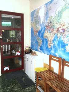 a room with a mural of a world on the wall at 拉瓦宅 輕旅店 - Lawa House #僅接待18-35歲青年旅人#Only for aged 18-35 in Chiayi City