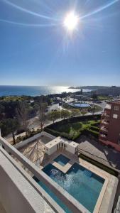 a view of a swimming pool with the ocean in the background at Da Rocha Beach 50M, AMAZING Sunset SEA VIEW in Portimão
