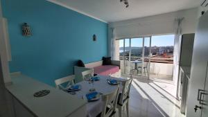 a living room with a table and chairs and a couch at Da Rocha Beach 50M, AMAZING Sunset SEA VIEW in Portimão