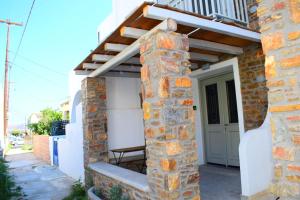 a house with a stone pillar and a porch at Zk House Kythnos in Mérikhas