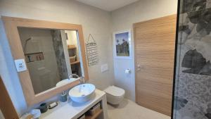 a bathroom with a sink and a toilet and a shower at Ta World apartments in Spodnji Log +26 photos