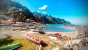 a group of boats sitting on the shore of a beach at Manou in Rivière-Pilote