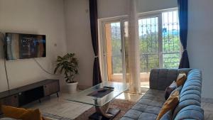 a living room with a couch and a glass table at Seaview SS palm terrace serviced apt-nyali in Mombasa