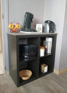 a black shelf with some items on it at Maison de campagne in Picherande +2 photos