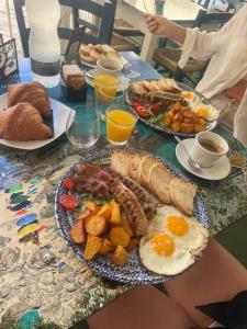 a table with a breakfast of eggs and other foods at Mare Fuori Apartment in Tropea +10 photos