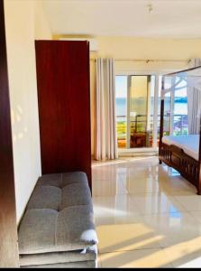 a bedroom with a bed and a view of the ocean at Seaview SS palm terrace serviced apt-nyali in Mombasa +9 photos