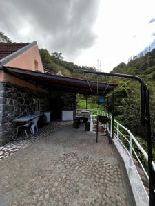 a building with a patio with a table and benches at Casa Duque in Santana with AC and heating in Santana