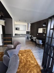 a living room with some chairs and a kitchen at Au Saint Martin in Cholet +13 photos