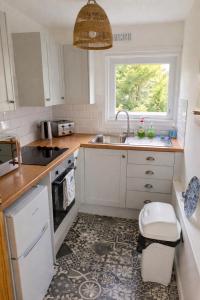a small kitchen with a sink and a window at Hillside Chalet in Kilkhampton