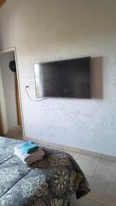 a flat screen tv on the wall of a bedroom at San Luis Aparts in Carpintería