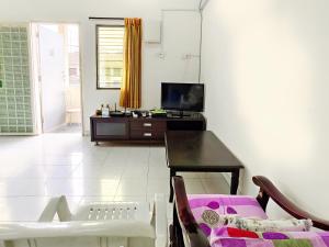 a living room with a table and a tv at 365 by D'Laksamana in Malacca