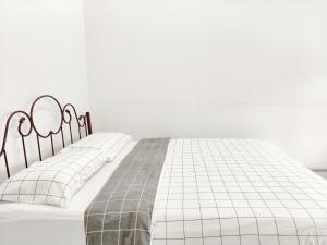 a white bed with two white pillows on it at 365 by D'Laksamana in Malacca