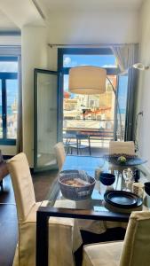 a living room with a table and chairs with a view at Faro Apartments in Chania