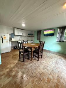 a kitchen with a table and chairs and a refrigerator at Lo de Nery in Ostende