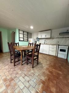 a kitchen with a wooden table and chairs in a room at Lo de Nery in Ostende