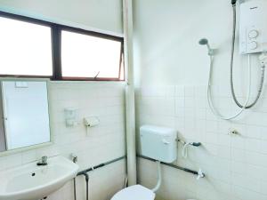a bathroom with a toilet and a sink and a shower at 365 by D'Laksamana in Malacca +5 photos
