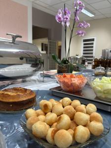 a table topped with plates of food and pies at Eventos e Hospedagem São José in Sorocaba