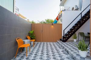 a patio with two chairs and a fence at Only U Home-Stay Villa Huahin in Hua Hin