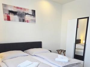 a bedroom with two beds and a mirror at Pension La Casa in Radolfzell am Bodensee