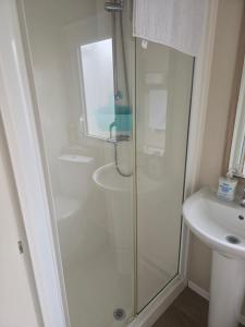 a bathroom with a shower and a sink at F86 Steeple Bay in Steeple +21 photos