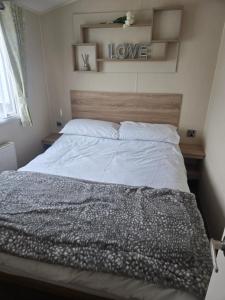 a bedroom with a large bed with aokedokedokedoked at F86 Steeple Bay in Steeple