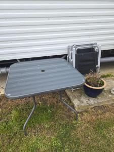a bench sitting in front of a trailer at F86 Steeple Bay in Steeple