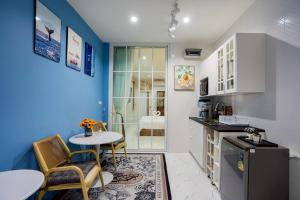 a kitchen with a table and two chairs and a table at Only U Home-Stay Villa Huahin in Hua Hin