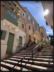 a group of stairs in front of a building at Dghajsa GUEST HOUSE in Senglea