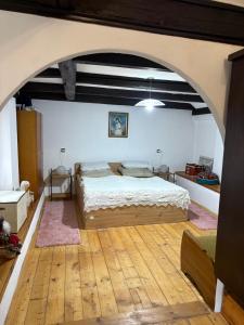 a bedroom with a large bed and an archway at Apartmán Amálka in Ktiš