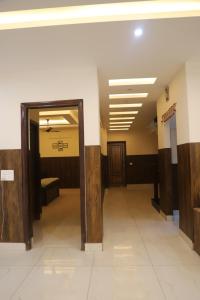 a hallway in a building with a door open at Aashray in Dehradun