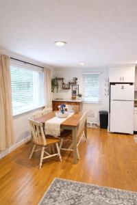 a dining room with a table and a kitchen at Cape Lake Private Beach Fire Table in Plymouth +22 photos