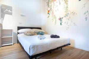 a bedroom with a bed with shoes on it at Colibrì in Milan
