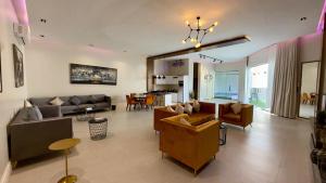 a living room with couches and a dining room at Fi Resorts - Riyadh in Riyadh