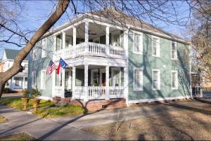 a large house with two american flags in front of it at 5BR Historic Downtown Edenton in Edenton