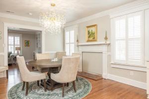 a dining room with a table and chairs and a fireplace at 5BR Historic Downtown Edenton in Edenton