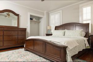 a bedroom with a bed and a dresser and a mirror at 5BR Historic Downtown Edenton in Edenton