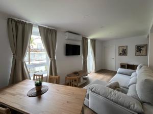 a living room with a couch and a table at Apartamentos Villacarriedo in Villacarriedo