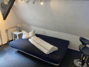 a bed with two pillows on it in a room at Fachwerkhaus Kürbis Bacharach in Bacharach