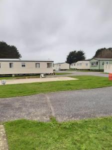 an empty parking lot with buildings in the background at Caravan Holiday Park in Newquay in Newquay