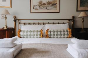 a bedroom with a bed with pillows on it at Clock View - Haworth in Haworth