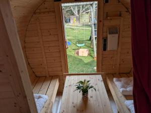 an inside view of a wooden house with a window at Schlaffass auf der Fischer-Ranch in Westerheim