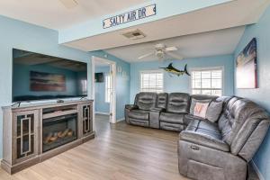 a living room with a couch and a tv at 1 Block to Surfside Beach: Home w/ Deck! in Freeport